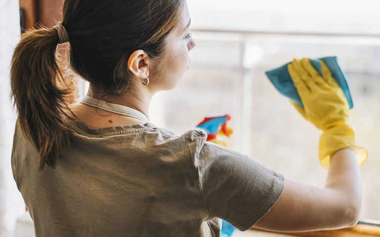 medium-shot-woman-cleaning-window